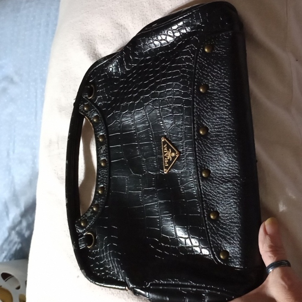 Black purse, hard handle with light damage